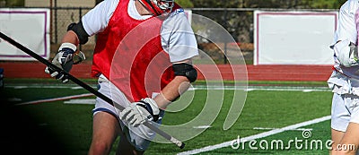 Lacrosse player running whith the ball during a scrimmage Editorial Stock Photo