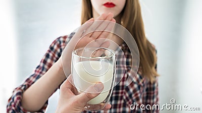 Lactose intolerance. Dairy Intolerant young girl refuses to drink milk Stock Photo