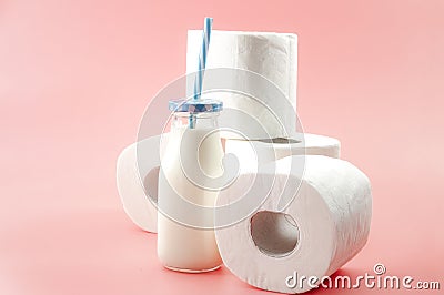 Lactose intolerance and the inability to digest milk concept theme with a bottle of milk with a blue straw and roll of toilet Stock Photo