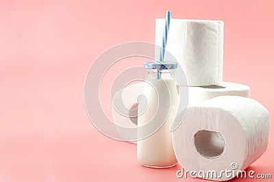 Lactose intolerance and the inability to digest milk concept theme with a bottle of milk with a blue straw and roll of toilet Stock Photo