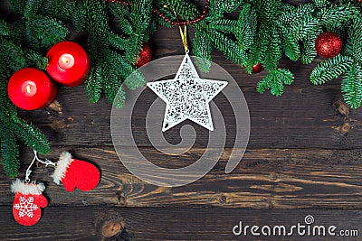 Lacy star, a pair of candles and fir branches on wooden boards, space for congratulations Stock Photo