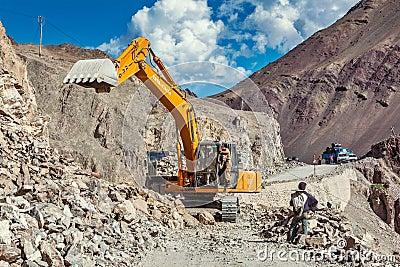 Excavator cleaning road after landslide in Himalayas Editorial Stock Photo