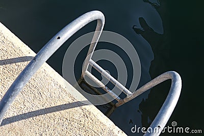 Ladder leading into the water Stock Photo