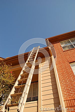 Ladder leaning on tall building Stock Photo