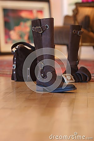 Ladies boots sitting on a wood floor Stock Photo