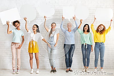 Ladies Holding Empty Speech Bubbles Standing Over White Wall Indoors Stock Photo