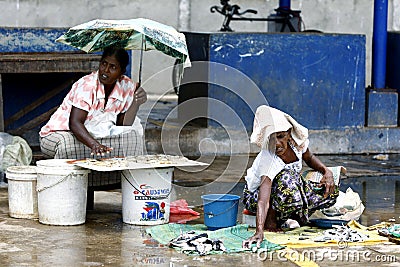 Ladies selling fish and crabs at the Negombo Fish Market in Negombo, Sri Lanka. Editorial Stock Photo
