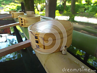 A ladle or a dipper to purify one`s hands and mouth at chozuya in a shinto shrine Stock Photo