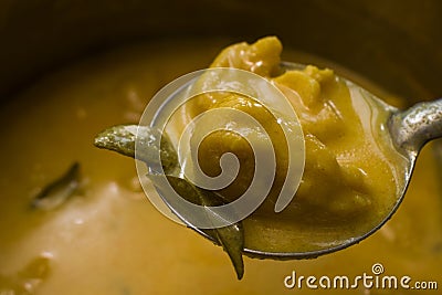 A ladle of pakoda kadhi or curry pakora Stock Photo