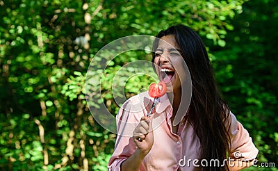 Lady attractive brunette eats tomato. Seductive appetite. Her appetite is sexy. Girl seductive eats red vegetable. Woman Stock Photo