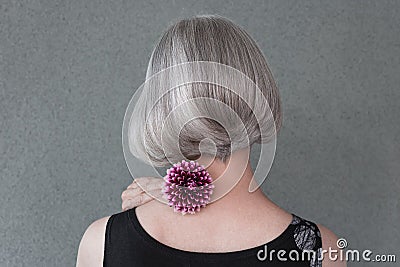 Lady with beautiful silver hair and red dahlia Stock Photo