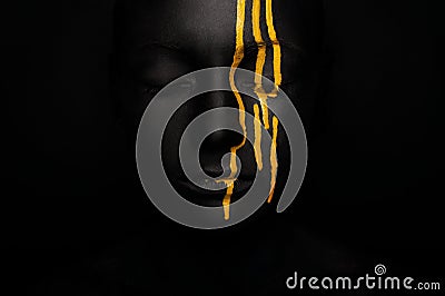 Lady in black paint with yellow smudges Stock Photo