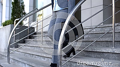Lady boss with briefcase walking stairs, office dress code, white collar style Stock Photo
