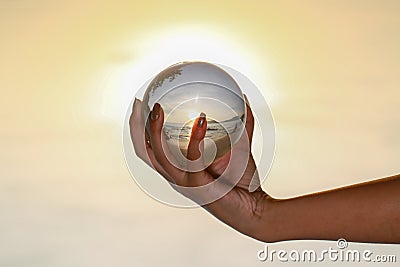 Catch the crystal ball with her finger Stock Photo