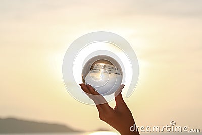 Catch the crystal ball with her finger Stock Photo