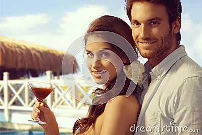 Lady with cocktail and boyfriend at tropical beach Stock Photo