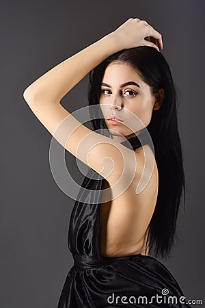 Lady, confident sexy girl in dress. Fashion concept. Attractive girl wears expensive fashionable evening dress with nude Stock Photo