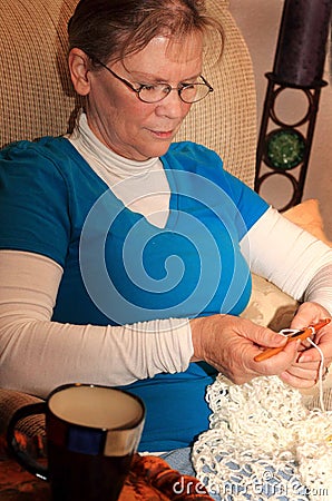 Lady Crocheting at Home Stock Photo
