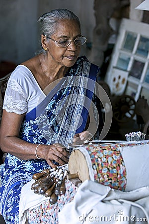 A lady demonstrates how to weave a tapestry at the Galle Fort Museum in Galle, Sri Lanka. Editorial Stock Photo