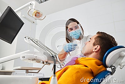 Stomatologist in the process of putting mouth opener Stock Photo