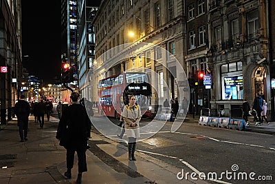 A lady enjoying a walk at night in central London, Uk Editorial Stock Photo