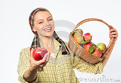 Lady gardener proud of her harvest. Woman gardener rustic style offer you apple on white background selective focus. Try Stock Photo