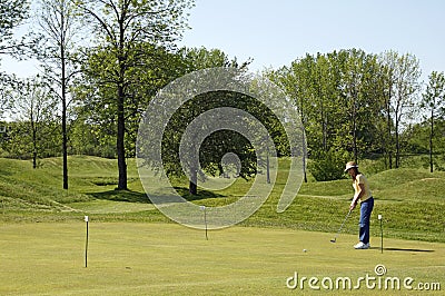 Lady On Golf Practice Green Stock Photo