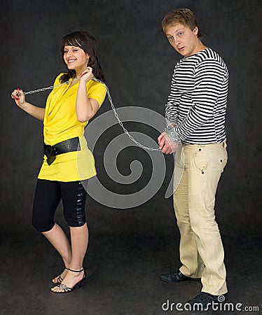 Lady guide shackled young man Stock Photo