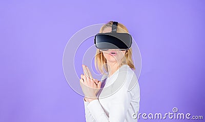 Lady with gun gesture. Enthralling interaction virtual reality. Woman head mounted display violet background. Virtual Stock Photo