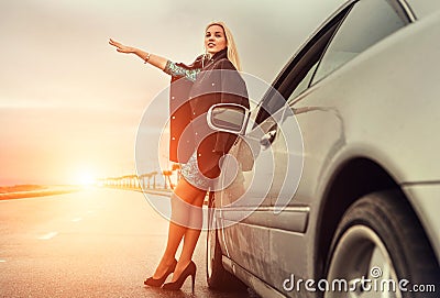 Lady in high heel shoes with broked car on the highway Stock Photo