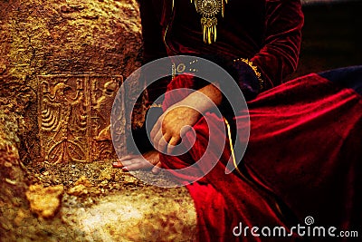 Lady in historic dress beside heraldic sign carved in stone. Vintage effect. Stock Photo