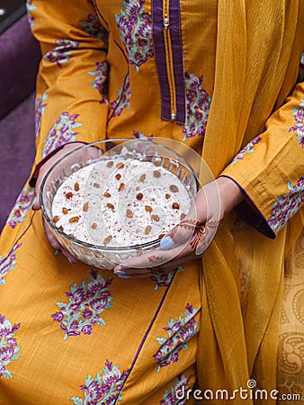 Lady holding kheer, rice pudding, dessert or sweet in hands. Food photography. Stock Photo