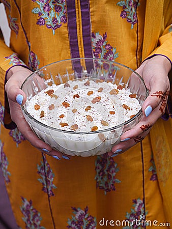 Lady holding kheer, rice pudding, dessert or sweet in hands. Food photography. Stock Photo