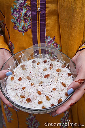 Lady holding kheer, rice pudding, dessert or sweet in hands. Food photography. Stock Photo