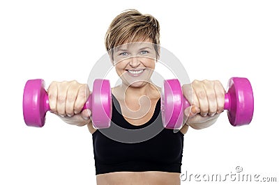 Lady holding pink dumbbells. Arms outstretched Stock Photo