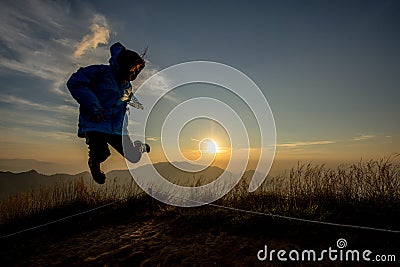 Lady in Jump action with sunset background Stock Photo