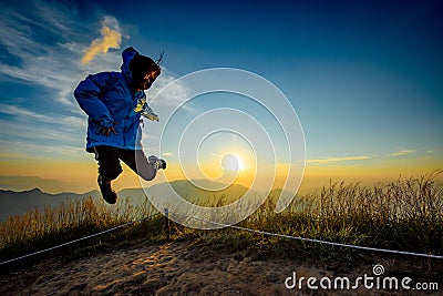 Lady in Jump action with sunset background Stock Photo