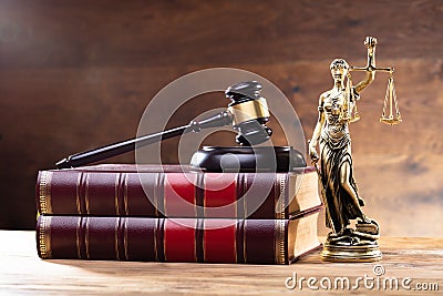 Lady Justice Near Gavel Over Law Book Stock Photo