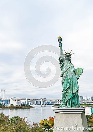 Lady liberty juxtaposed against Rainbow Bridge in Tokyo. Editorial Stock Photo