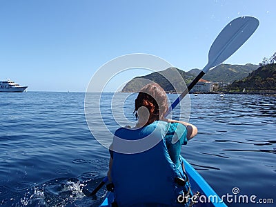 Lady Paddles Kayak toward Catalina Island Stock Photo