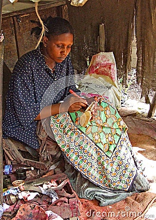 Lady painting at Akamba Handicraft Industry Cooperative Society Mombassa Editorial Stock Photo