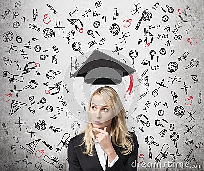 A lady is pondering over the advantages of education. Stock Photo