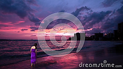 Lady in purple walking on Waikiki Beach, Hawai Stock Photo