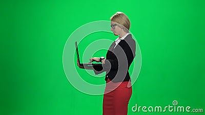 Lady with laptop in hand. Green screen Stock Photo