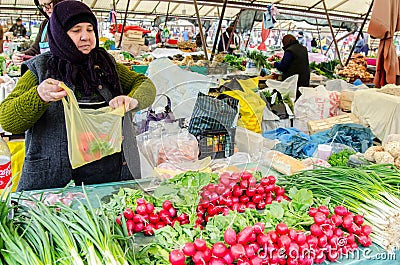 Lady selling fresh vegetables at the market Editorial Stock Photo