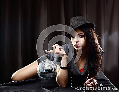 lady with shiny disco ball, lying on the table Stock Photo