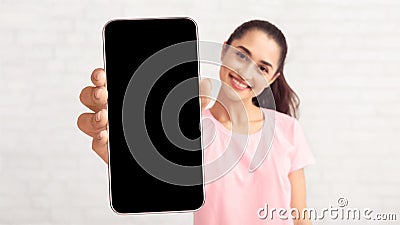 Lady showing white empty smartphone screen, closeup Stock Photo