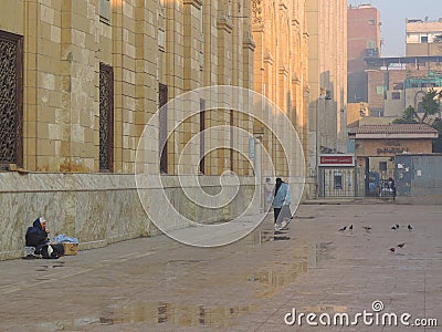 Lady sitting in the lane adjoining Al-Hussein mosque Editorial Stock Photo