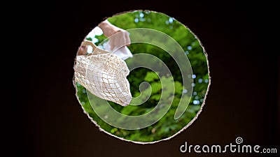 Lady taking reusable trash from crochet bag to throw into container, utilize Stock Photo