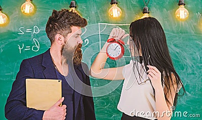 Lady teacher and strict schoolmaster care about discipline and rules in school. School rules concept. Man with beard Stock Photo